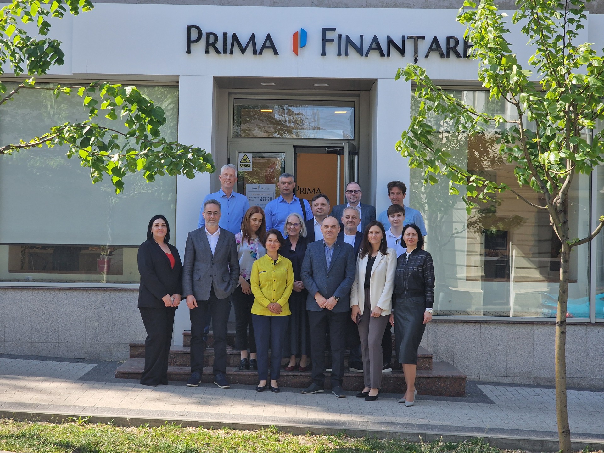 Large group of AgriPlus+ team members and partners posing for a photo outside the Prima Finanțare office in Moldova